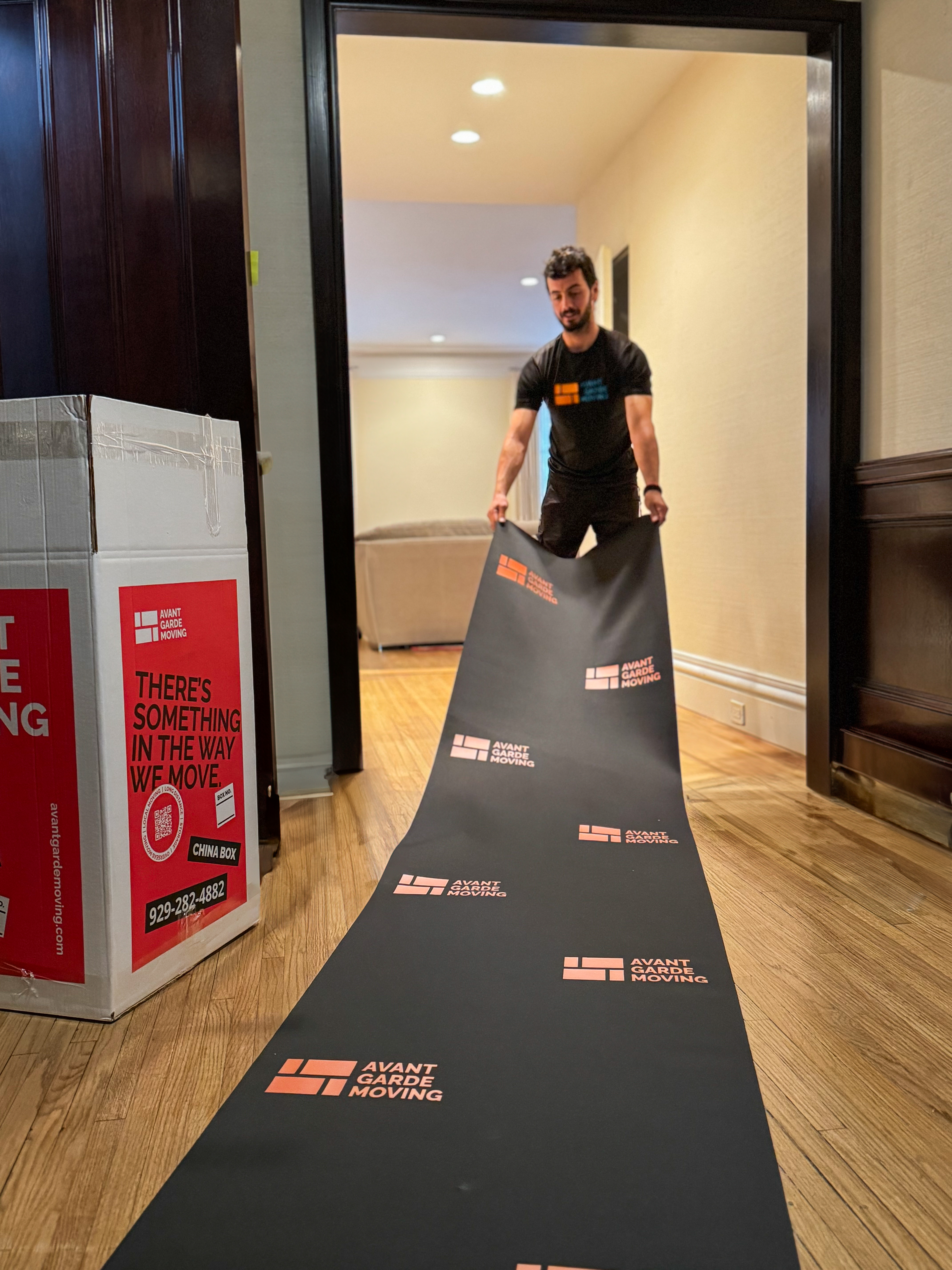 Moving crew protecting Manhattan building lobby with floor mats
